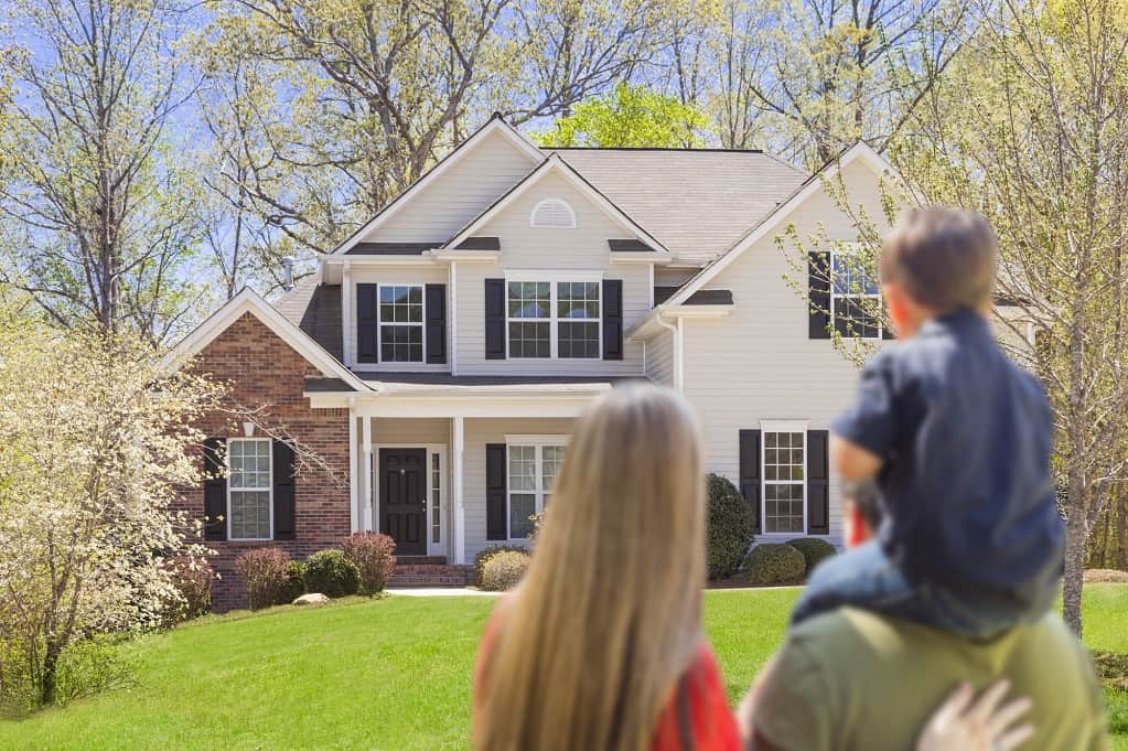 Young Family Looking At Their New House Young Family Looking At Their New House